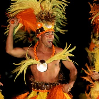 a group of people sitting around a christmas tree