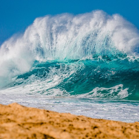 a person riding a wave on a surfboard in the ocean